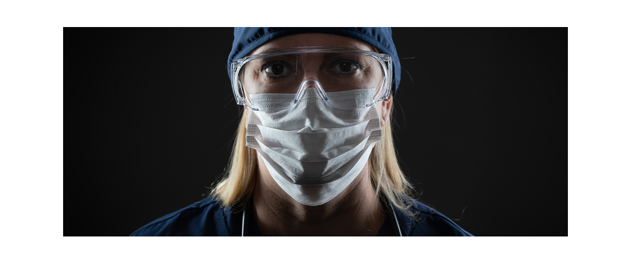 Female clinician in PPE with black background