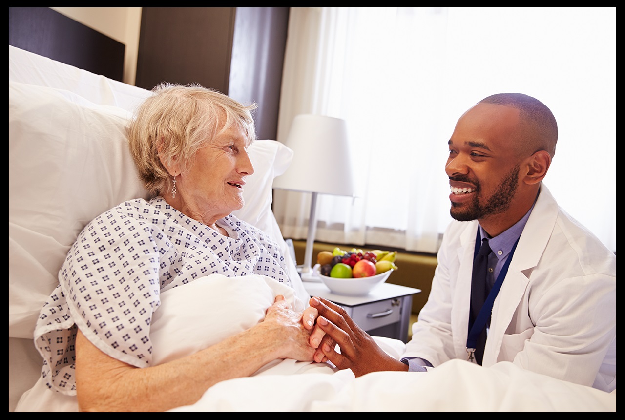 Doctor holding an elderly woman's hand